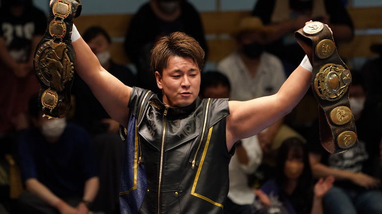 Yuma Aoyagi raising Tag Championships