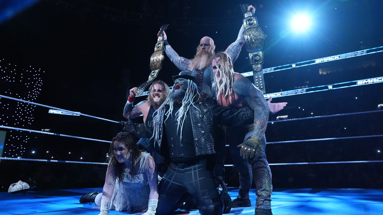 The Wyatt Sicks pose with the SmackDown tag titles