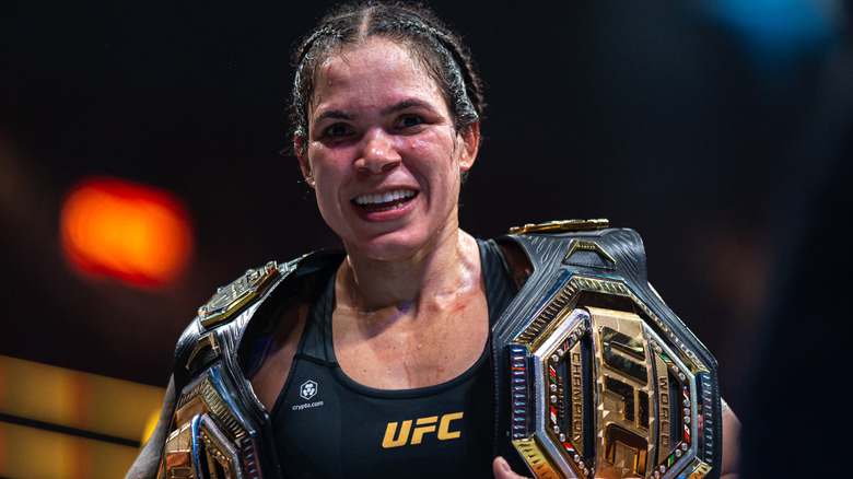 Amanda Nunes with the UFC Bantamweight and Featherweight titles