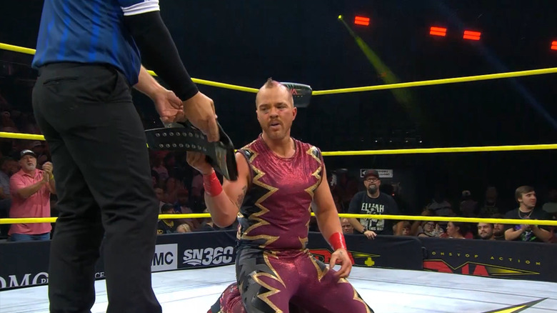 Amazing Red is presented the X-Division Championship belt
