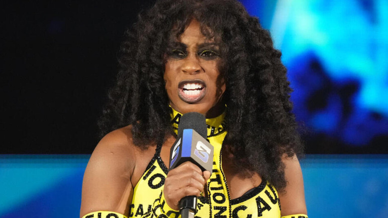 Naomi barks on the microphone in her 