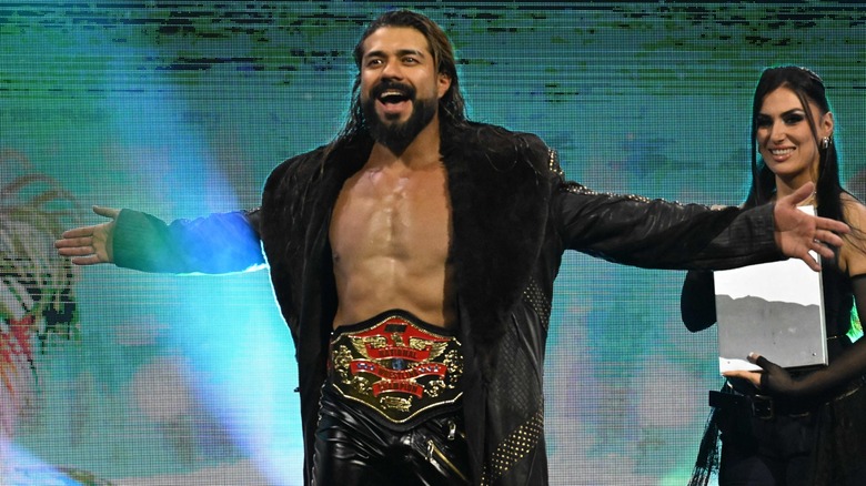 Andrade El Idolo making his way to the ring for his match against Tommaso Ciampa and Samoa Joe, alongside Will Ospreay at 