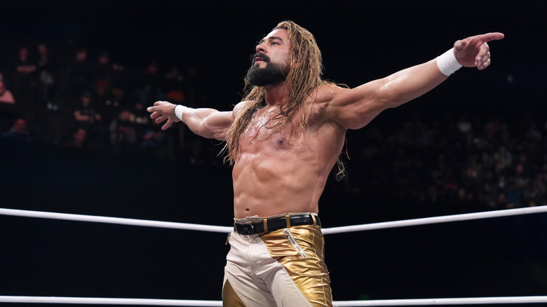Andrade poses in the ring during a match on an episode of 