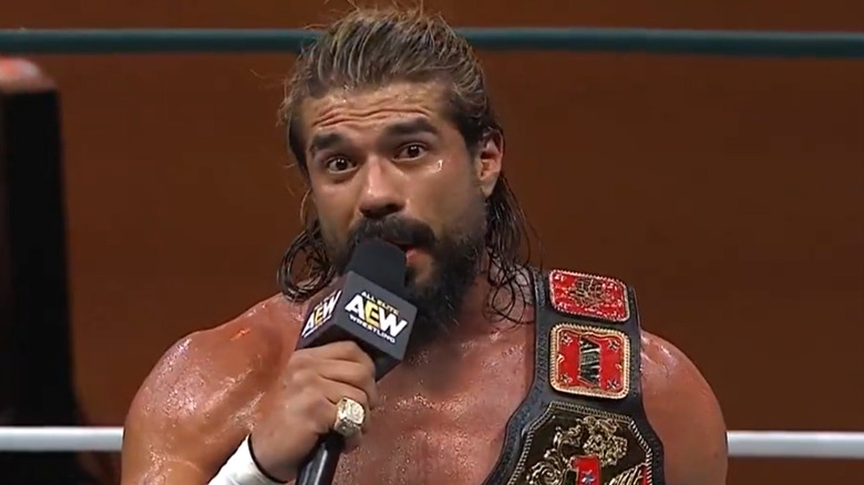 Andrade on the microphone in the ring