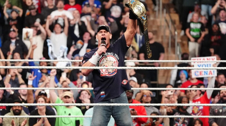 John Cena cuts a promo in the middle of the ring, holding up the Intercontinental Championship, on an episode of 