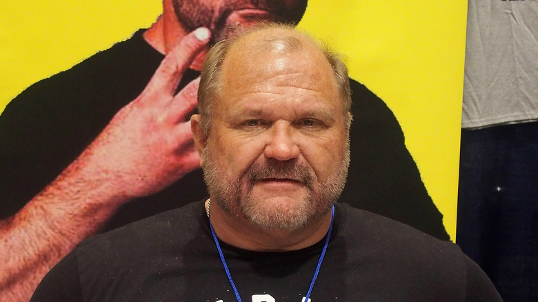 Arn Anderson, thrilled to be standing in front of a photo of Arn Anderson