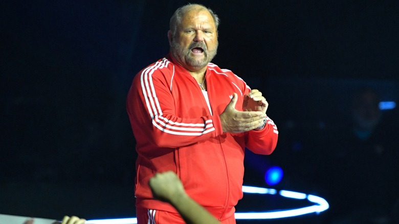 Arn Anderson applauds on his way to the ring