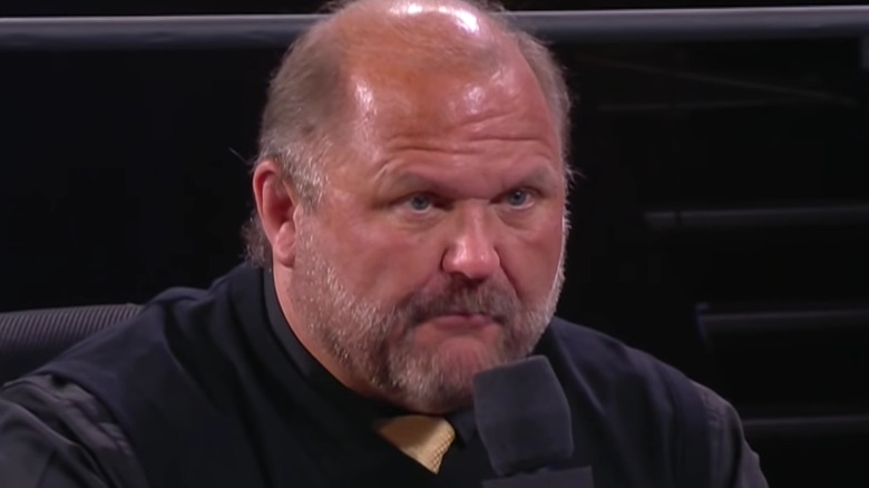 Arn Anderson holding a microphone