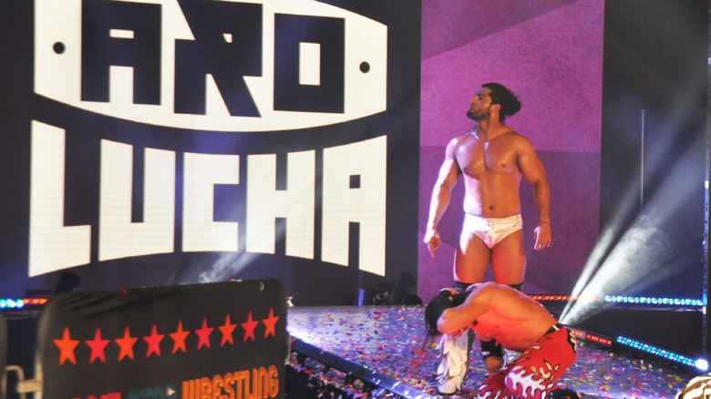 Rush stares at the Aro Lucha logo