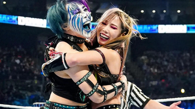 Asuka and Kairi Sane, known collectively as The Kabuki Warriors, embrace.