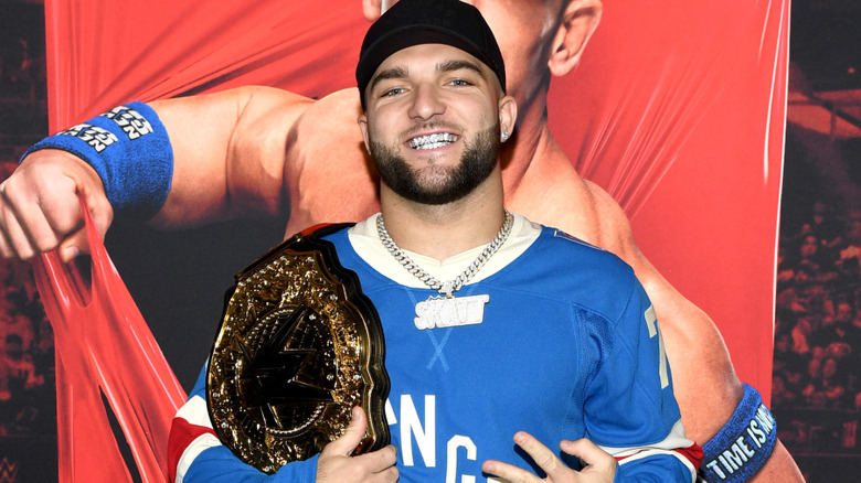 Cam Skattebo holding a replica WWE championship