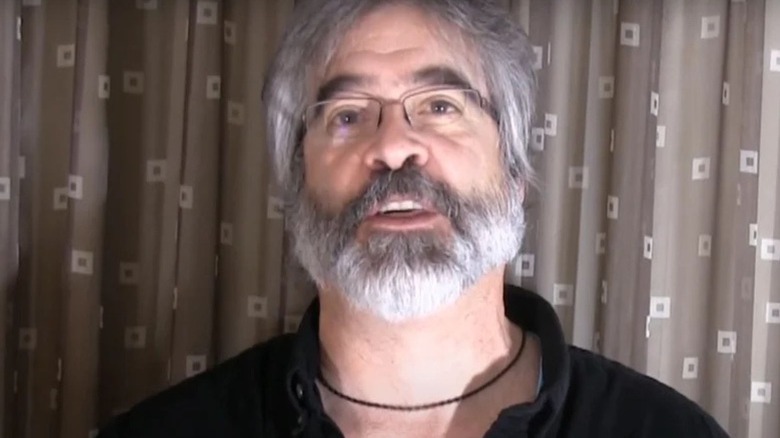 Vince Russo speaks into a camera during an interview for a YouTube series.