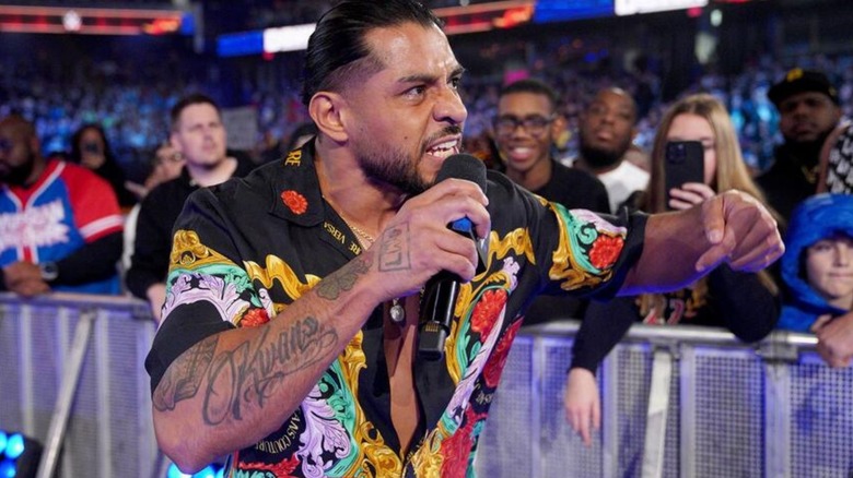 Santos Escobar cuts a promo on the ramp while heading to the ring during an episode of WWE programming.