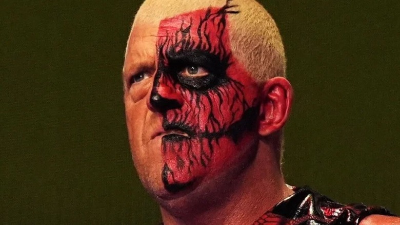 AEW's Dustin Rhodes stands with half his face painted before a match.