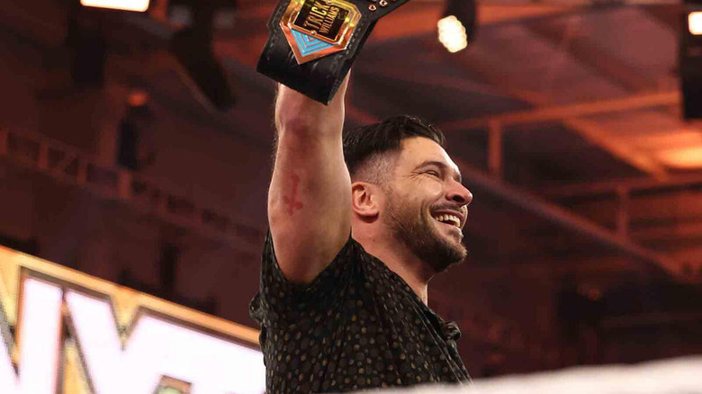 Ethan Page holds the NXT Title high