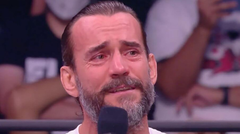 CM Punk with a microphone in AEW