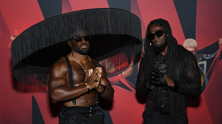 Austin Creed wears a large hat while hanging out with Kofi