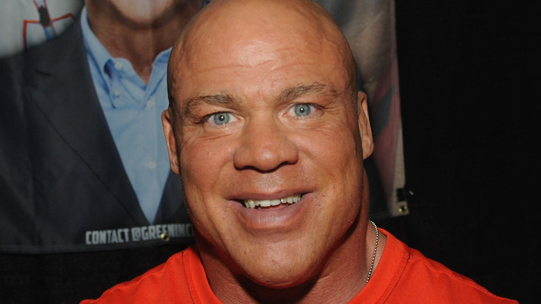 Kurt Angle smiling in a suit