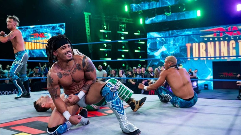 Dezmond Xavier flashes a smile after helping his Rascalz buddies (pictured Zachary Wentz and Myron Reed) secure a win at TNA Turning Point