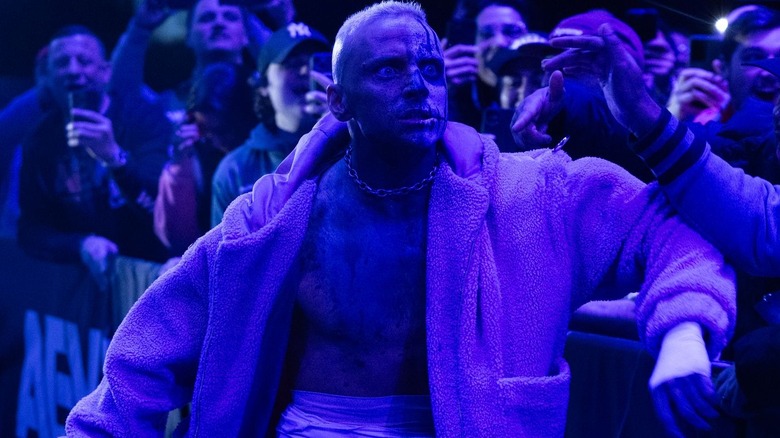 Darby Allin makes his entranced bathed in purple light.