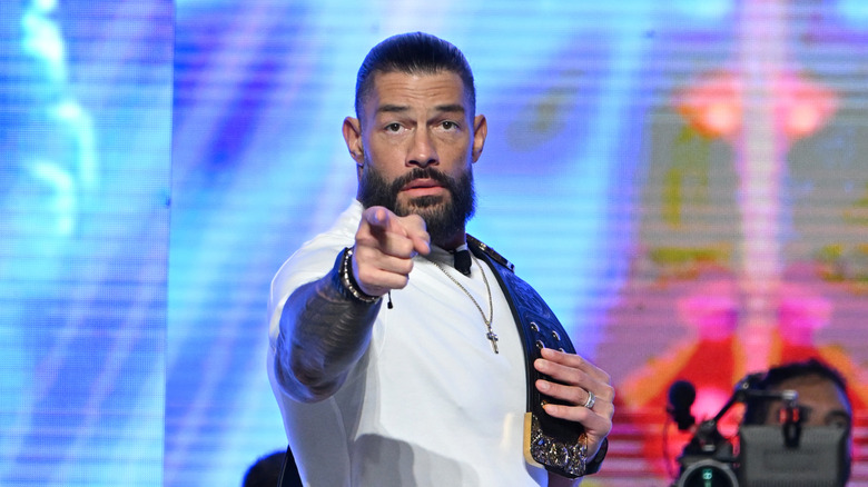 Roman Reigns pointing to his alignment on WWE's internal roster