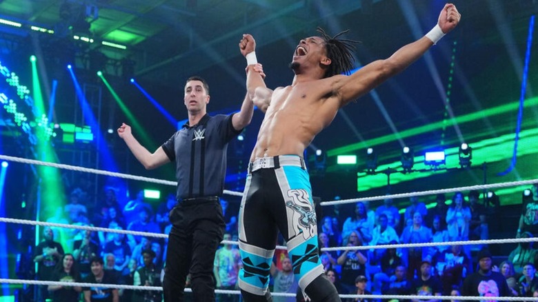 A referee holds up the arm of EK Prosper, formerly known as Eli Knight, after a win on 