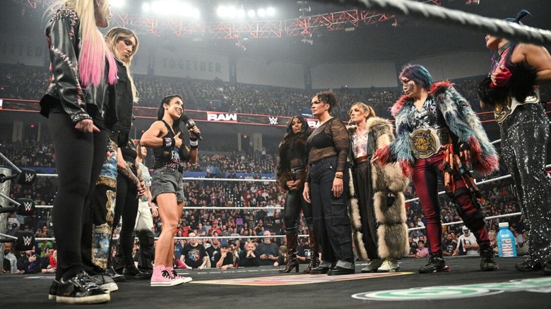The members of the babyface and heel women's WarGames teams stare each other down in the middle of the ring on the go-home episode of 