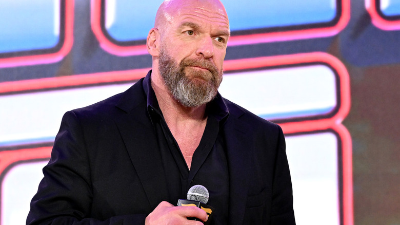 Triple H holding a microphone