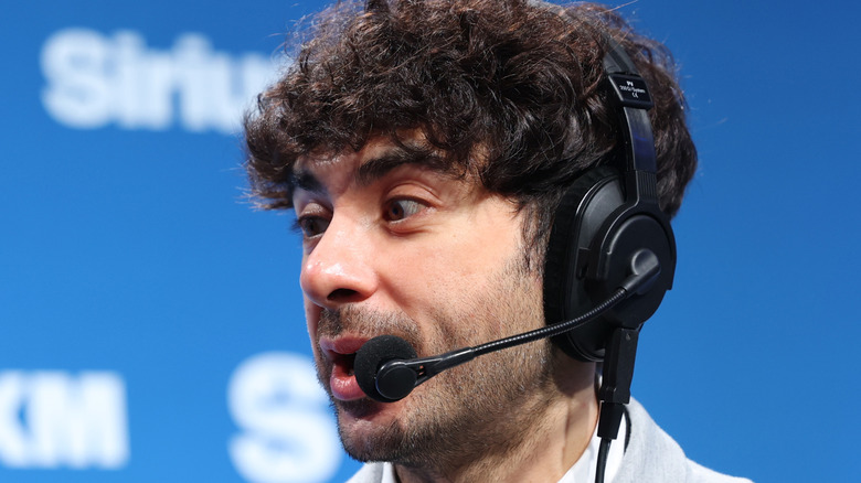 Tony Khan wearing a headset at a SiriusXM event
