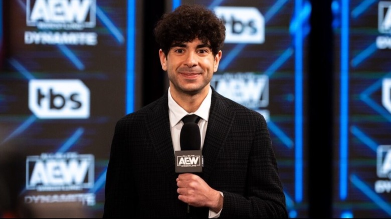 AEW President Tony Khan smiles on before giving an announcement on AEW programming