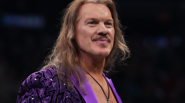 Chris Jericho smiles in a bedazzled purple suit.