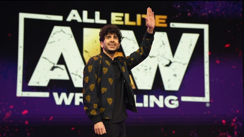 AEW President Tony Khan waves to the crowd during an AEW event