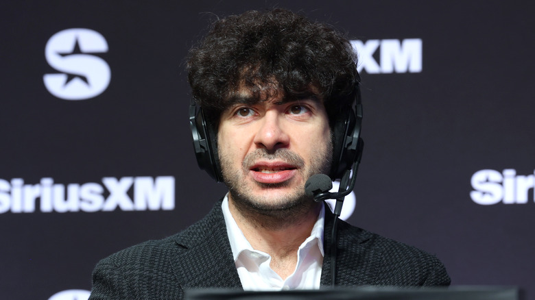 Tony Khan speaks through the headset