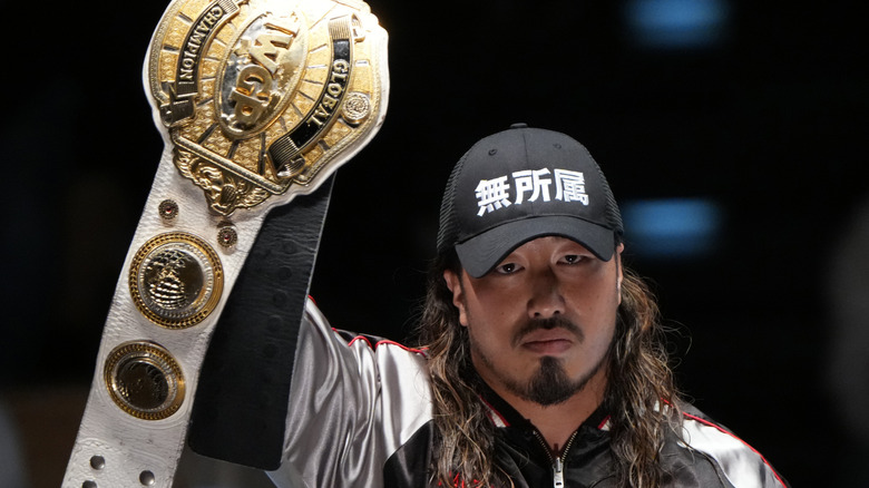 NJPW star Yota Tsuji proudly holds up his newly won IWGP Global Heavyweight Championship