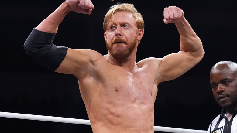 Orange Cassidy flexing his arms