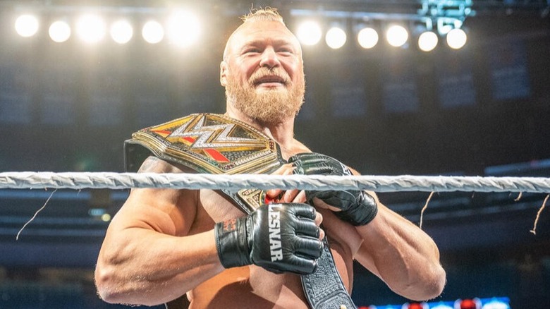 Brock Lesnar, carrying the WWE Championship at the time, awaits his challenger in the ring