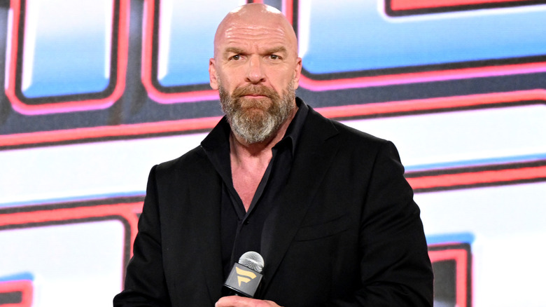 Triple H holding a microphone