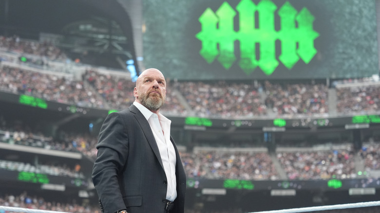 Triple H looks out into the crowd after welcoming them to WrestleMania