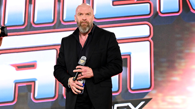 Triple H prepares to greet the fans at a SummerSlam press event