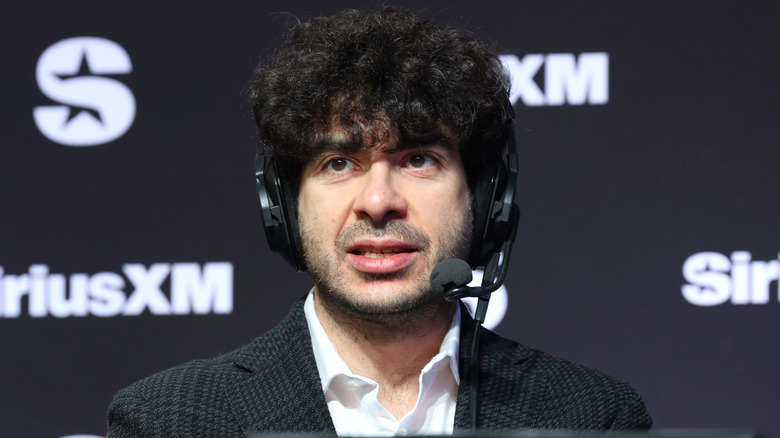 Tony Khan speaking with a headset on