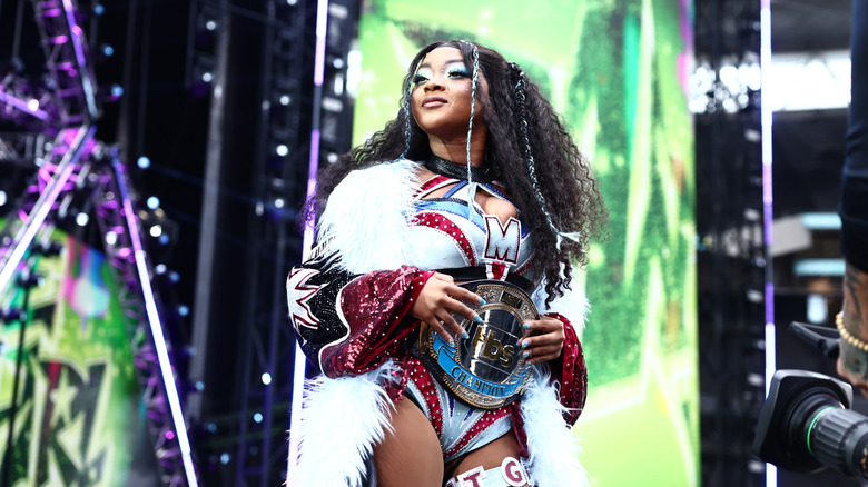 TBS Champion Maya World looks to the crowd, title around her waist, before walking down the ramp to the ring for her match at AEW All In London 2026.
