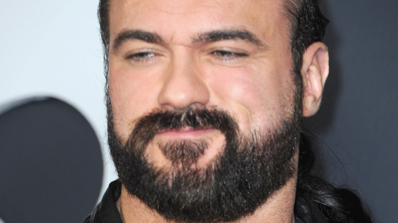 Drew McIntyre smiles at a press event 