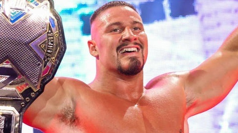 Bron Breakker showing off the NXT Title