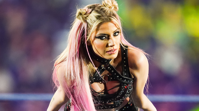 Alexa Bliss leaning against the ring ropes