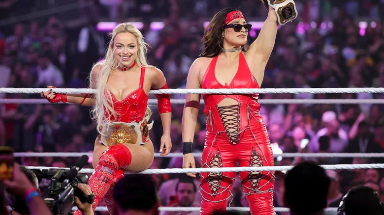 Liv Morgan and ⁣Raquel Rodriguez holding their WWE ⁣Women's Tag Team titles.