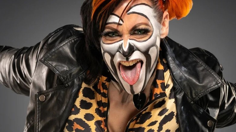 Rosemary, decked out in face paint, poses for the camera during a backstage photoshoot in TNA.