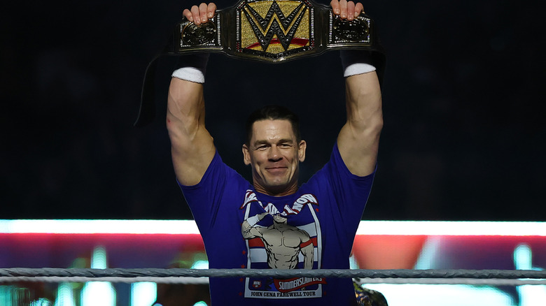 John Cena holding the Undisputed WWE Championship above his head before his SummerSlam match against Cody Rhodes, 2025.