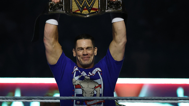 John Cena holding the Undisputed WWE Championship above his head before his SummerSlam match against Cody Rhodes, 2025.