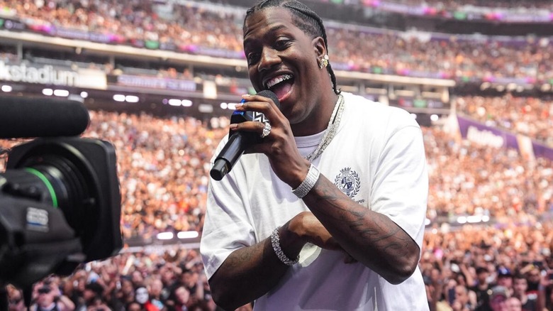 Lil Yachty looks to a camera on stage while introducing then-United States Champion Trick Williams ahead of his match against Baron Corbin at WWE SummerSlam 2026.