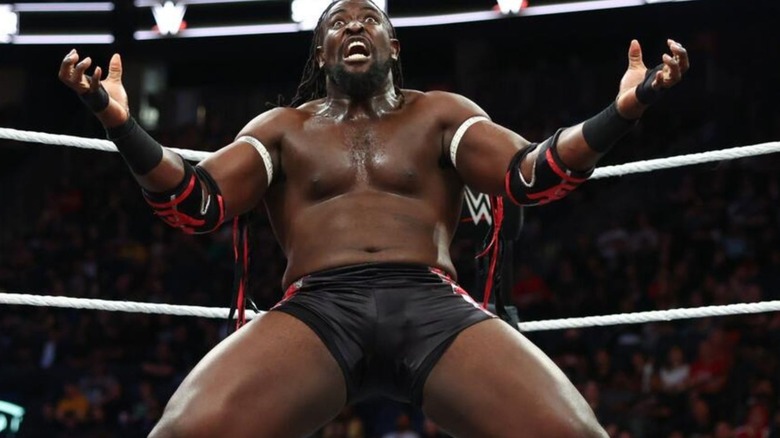 Oba Femi hits a pose in the corner before delivering a move to his opponent in the ring on 
